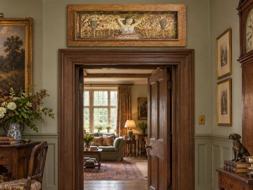 fig 7. A rectangular Arts and Crafts polychrome plaster relief featuring a central classical figure framed by trees and inscribed Ave Epicurus within a gilt frame.