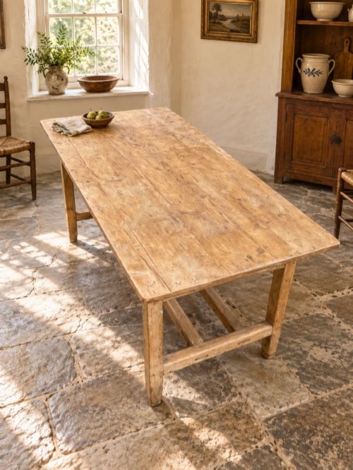 fig 2. A 19th century rectangular Irish pine farmhouse table featuring square legs, lower H-stretchers, and a warm timber finish.