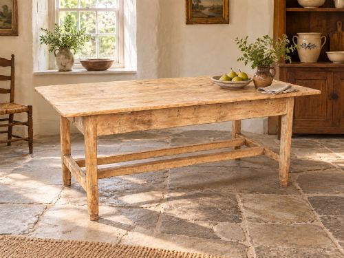 fig 4. A 19th century rectangular Irish pine farmhouse table featuring square legs, lower H-stretchers, and a warm timber finish.
