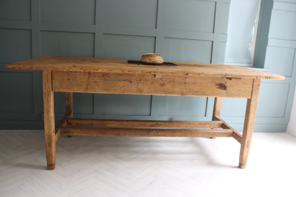 A 19th century rectangular Irish pine farmhouse table featuring square legs, lower H-stretchers, and a warm timber finish. View III