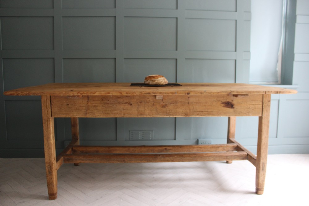 A 19th century rectangular Irish pine farmhouse table featuring square legs, lower H-stretchers, and a warm timber finish. View V