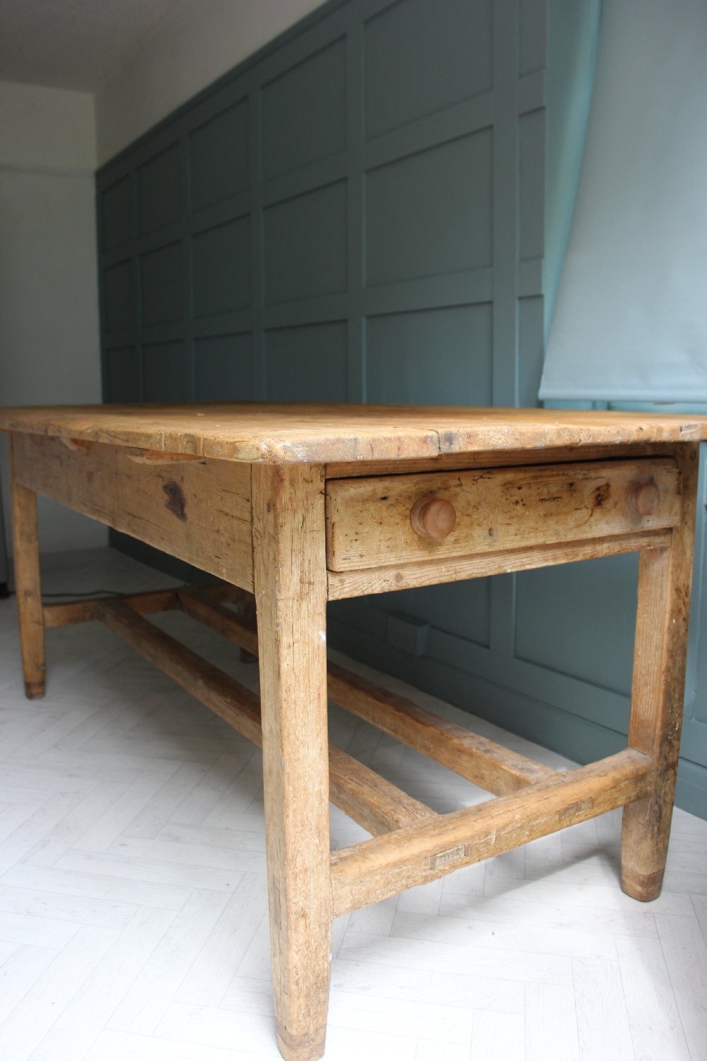 A 19th century rectangular Irish pine farmhouse table featuring square legs, lower H-stretchers, and a warm timber finish. View VIII