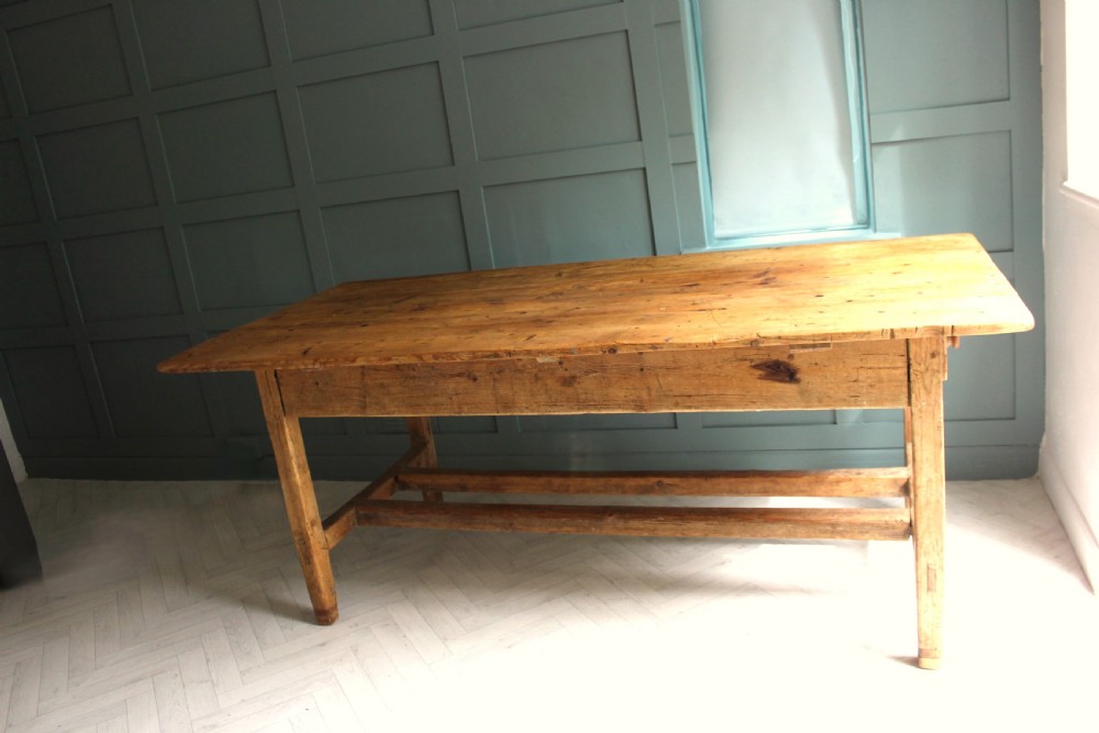 A 19th century rectangular Irish pine farmhouse table featuring square legs, lower H-stretchers, and a warm timber finish. View IX