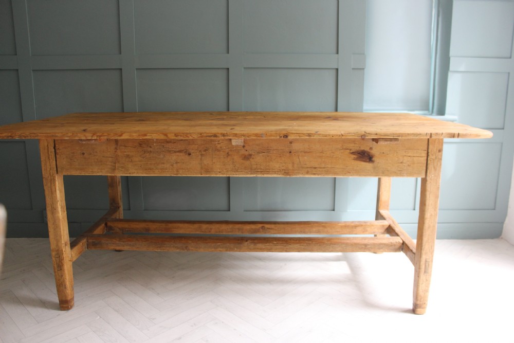 A 19th century rectangular Irish pine farmhouse table featuring square legs, lower H-stretchers, and a warm timber finish. View XI