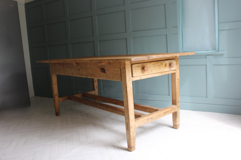 A 19th century rectangular Irish pine farmhouse table featuring square legs, lower H-stretchers, and a warm timber finish. View XIV