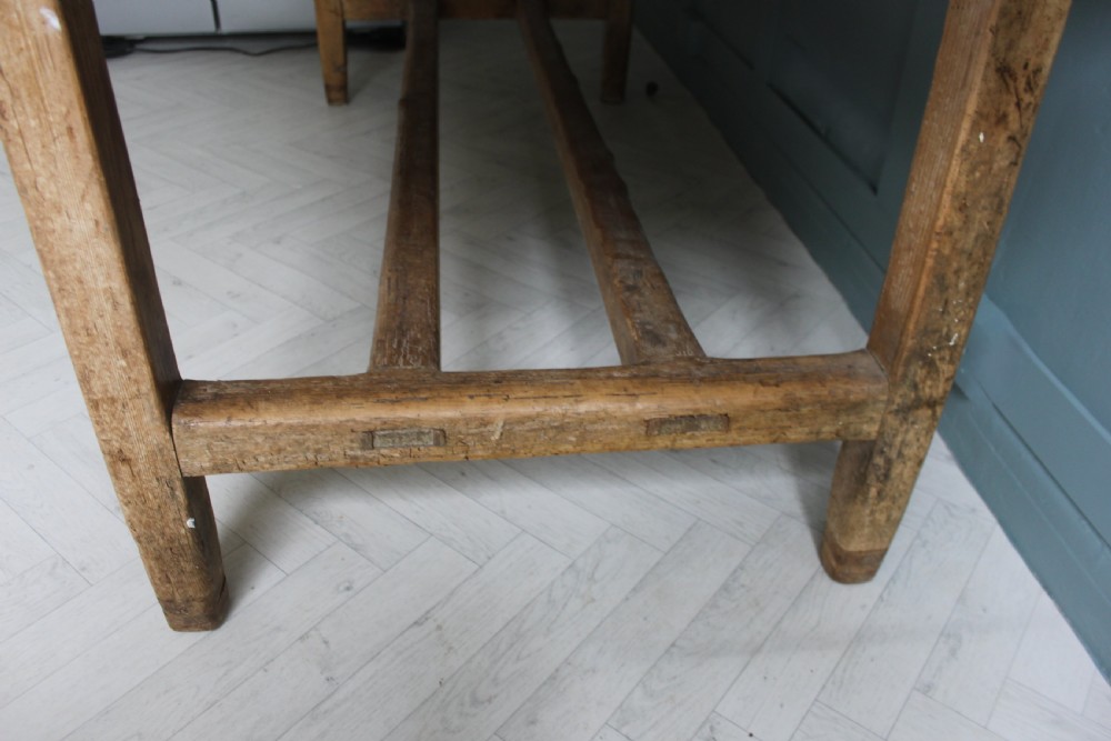 A 19th century rectangular Irish pine farmhouse table featuring square legs, lower H-stretchers, and a warm timber finish. View XVII