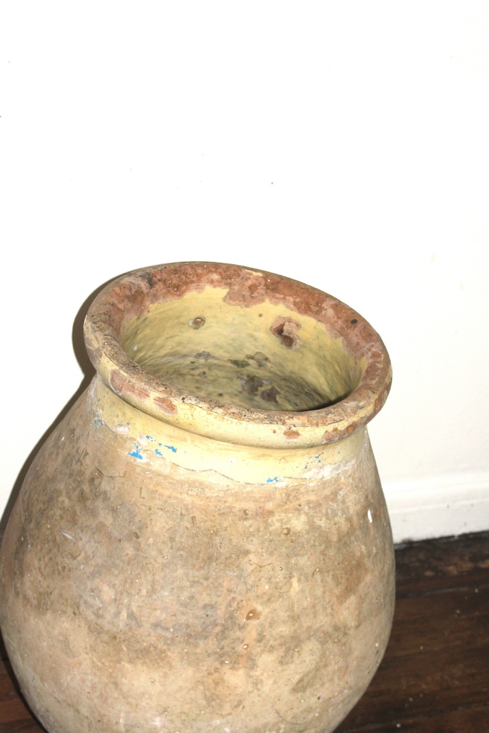 A 19th-century French terracotta Biot jar featuring an unglazed weathered body and a round lip finished with yellow glaze. View IV
