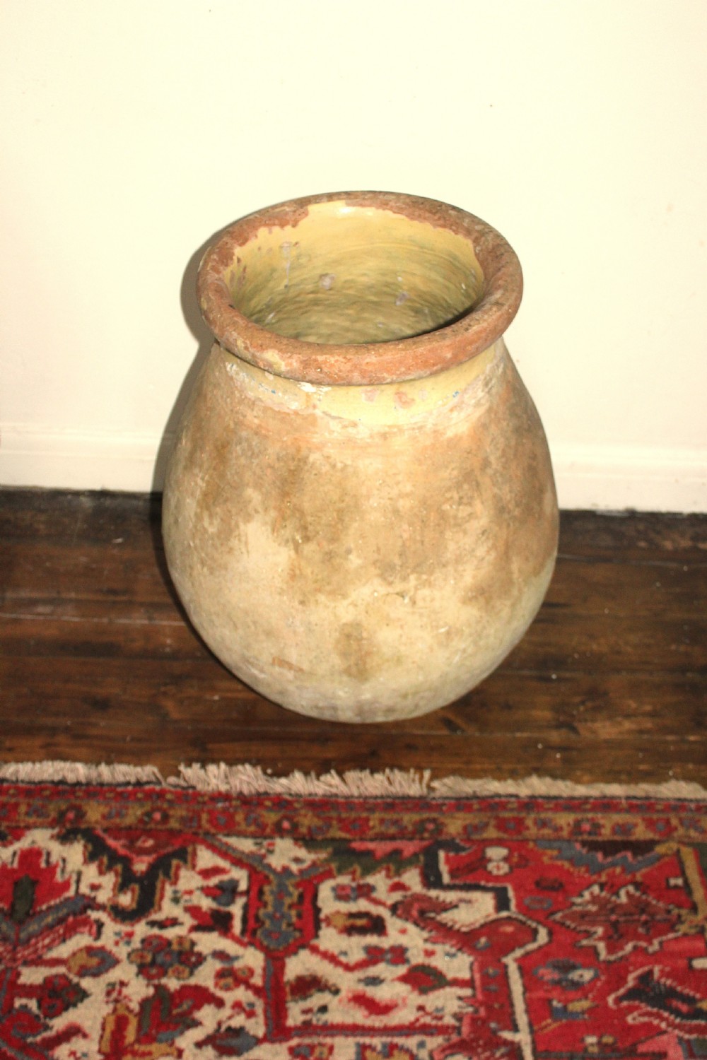A 19th-century French terracotta Biot jar featuring an unglazed weathered body and a round lip finished with yellow glaze. View VIII