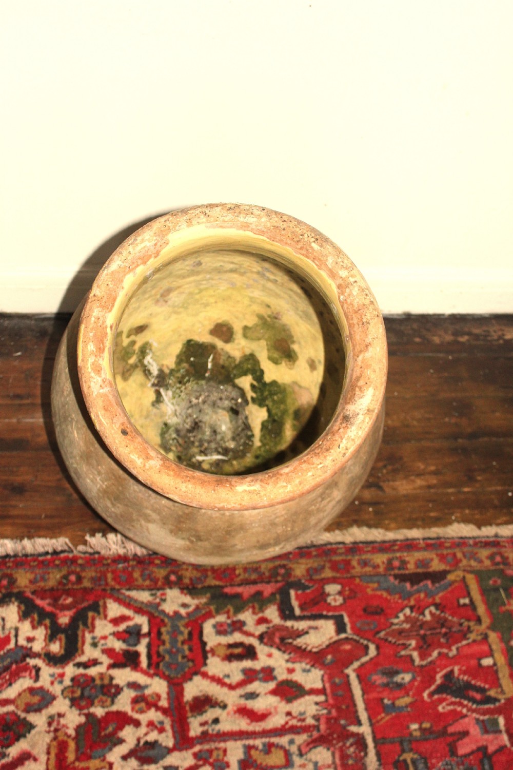 A 19th-century French terracotta Biot jar featuring an unglazed weathered body and a round lip finished with yellow glaze. View IX