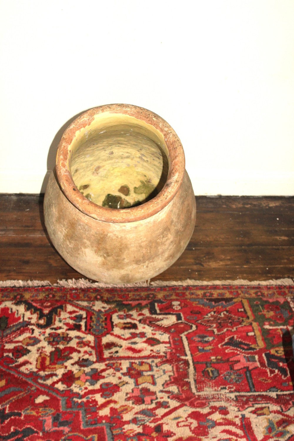 A 19th-century French terracotta Biot jar featuring an unglazed weathered body and a round lip finished with yellow glaze. View XI