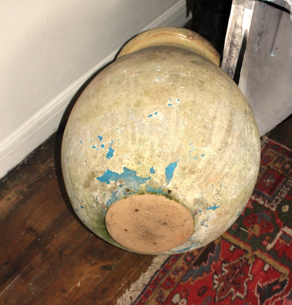 A 19th-century French terracotta Biot jar featuring an unglazed weathered body and a round lip finished with yellow glaze. View XIII