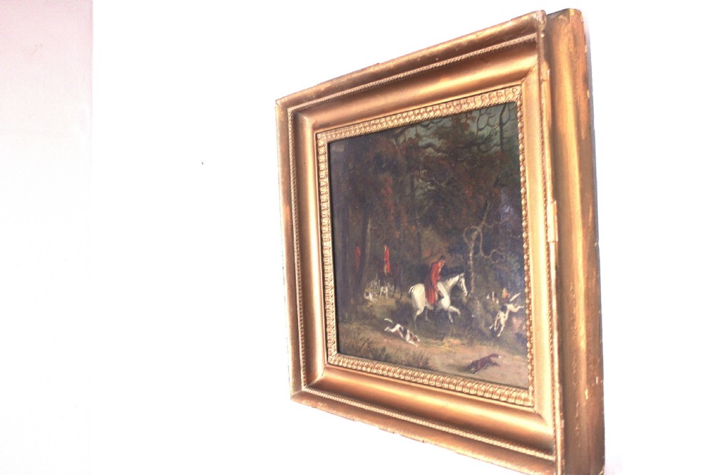 An early 19th-century oil painting depicting horse riders in red coats with hunting hounds pursuing a fox through a woodland, set in a gilded frame. View VII