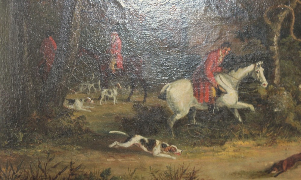 An early 19th-century oil painting depicting horse riders in red coats with hunting hounds pursuing a fox through a woodland, set in a gilded frame. View IX