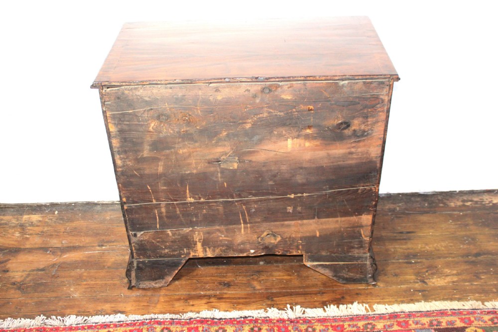 A George II mahogany chest of drawers featuring four graduated drawers with brass handles and supported on ogee bracket feet. View XII