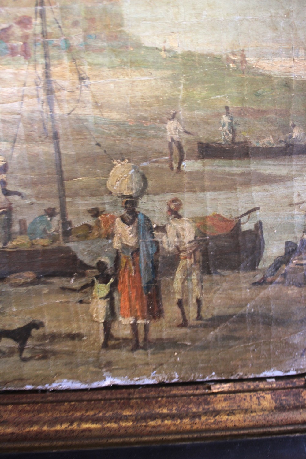 An octagonal framed early 19th-century oil painting depicting a Brazilian coastal landscape with colonial buildings, figures along the shore, and boats on the water. View IX