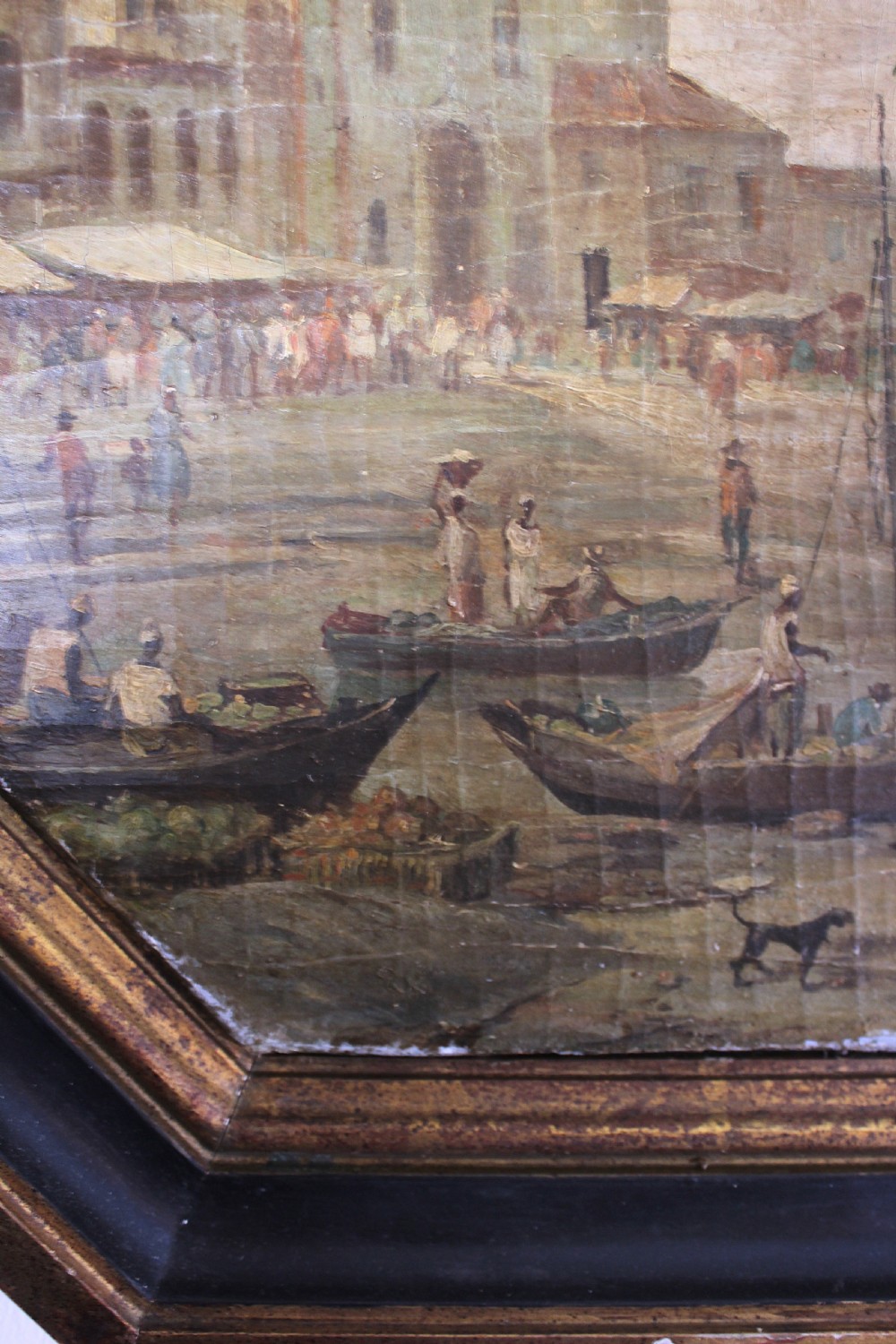 An octagonal framed early 19th-century oil painting depicting a Brazilian coastal landscape with colonial buildings, figures along the shore, and boats on the water. View XV