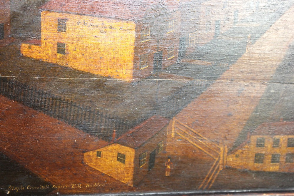 An 18th-century naive topographical oil painting of Staplecross in Sussex depicting village roads, buildings, and a windmill in a dark wooden frame. View VI