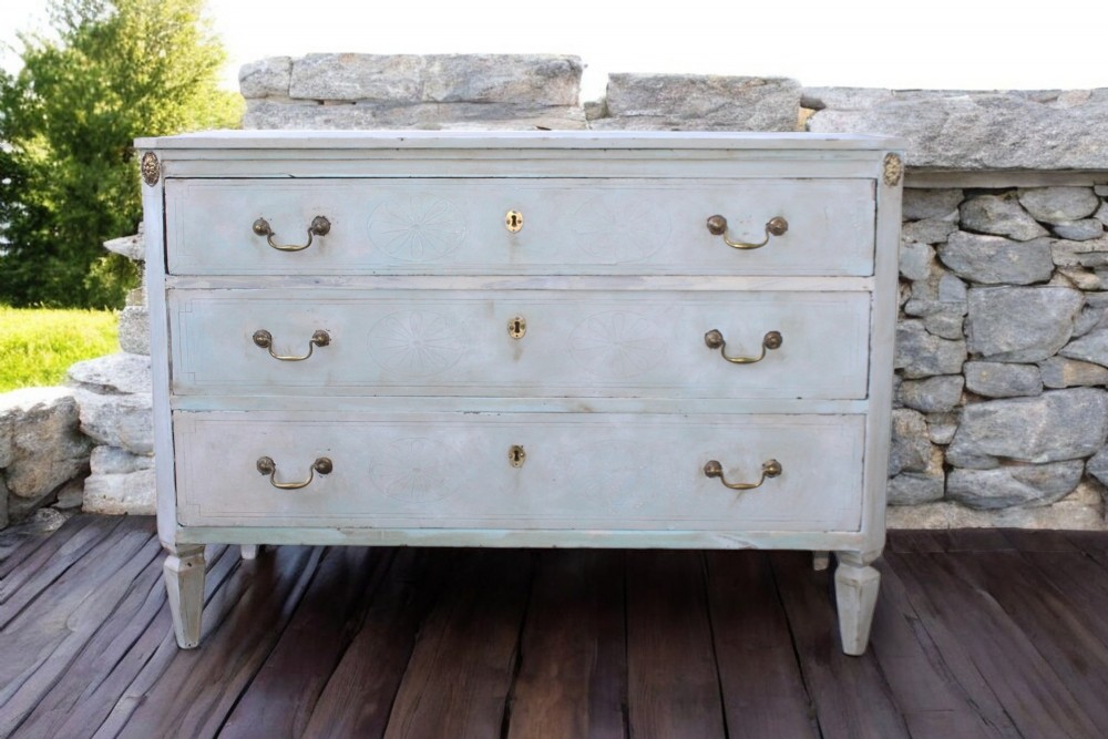 An 18th-century Gustavian light blue painted chest of drawers featuring three long drawers with brass handles and tapered fluted legs. View XXI