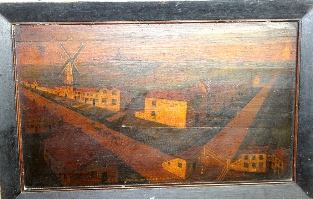An 18th-century naive topographical oil painting of Staplecross in Sussex depicting village roads, buildings, and a windmill in a dark wooden frame.