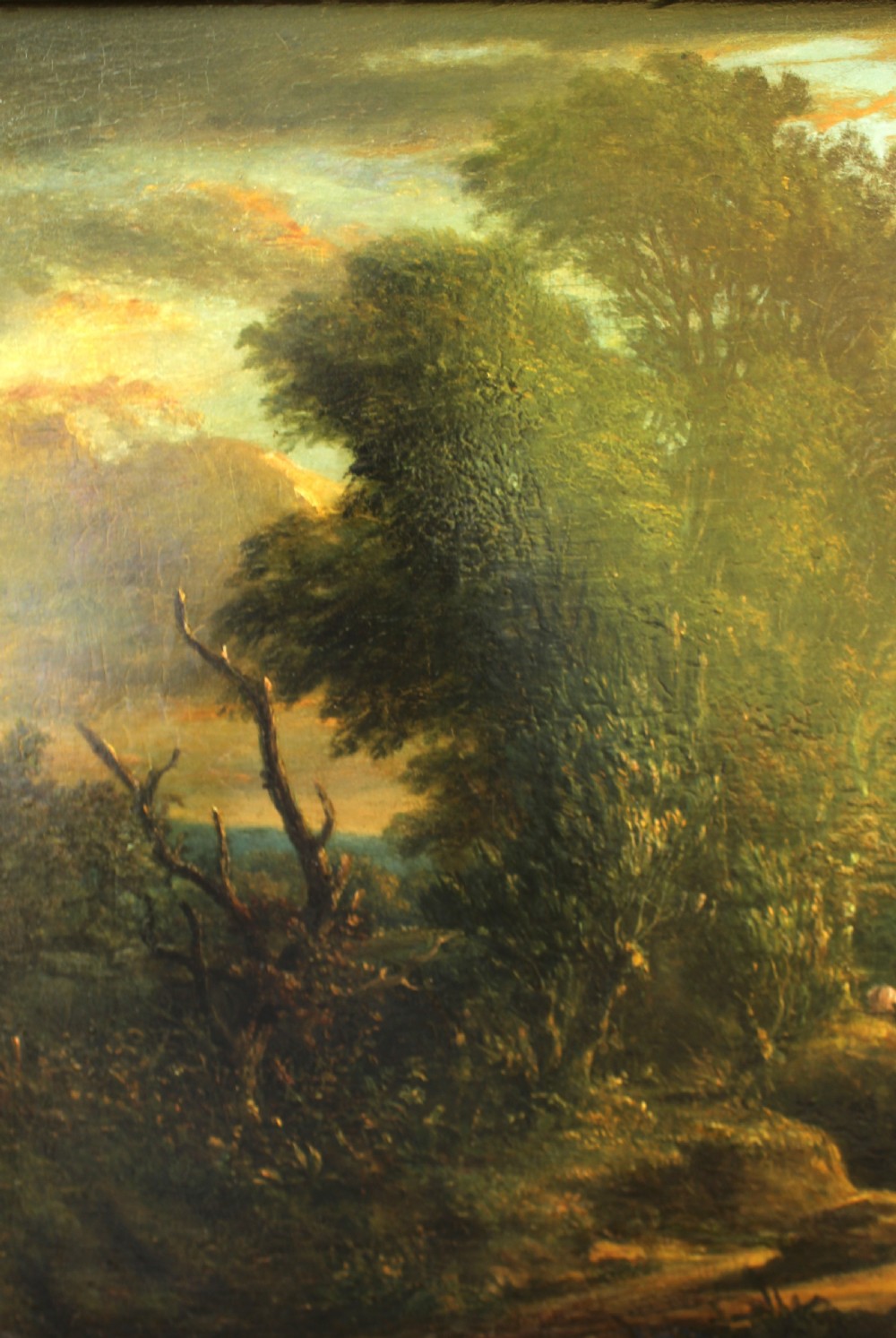A 19th-century English pastoral oil painting depicting trees, hills, and figures beside a body of water in a moulded gilt frame. View III