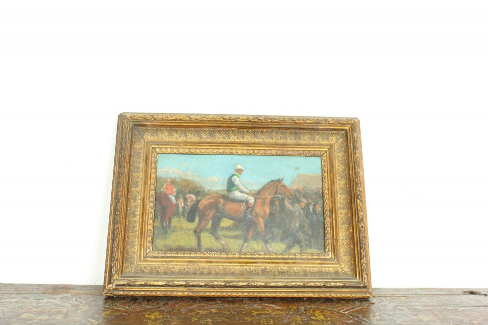 An early 20th-century impressionistic oil painting of a mounted jockey on a bay racehorse in a paddock, framed in a carved gilded wooden frame. View VIII