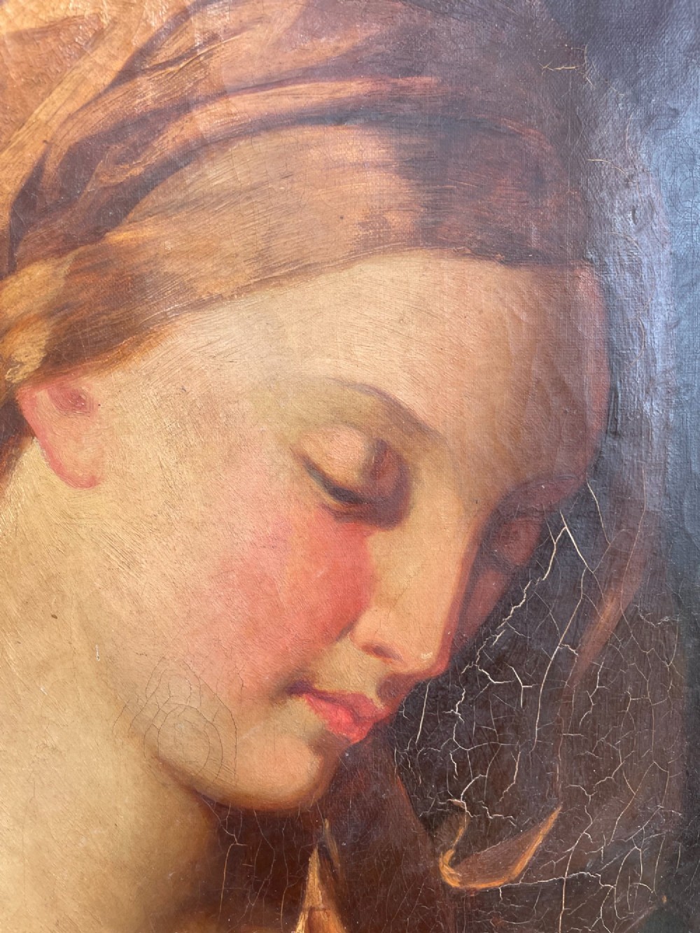 An 18th-century oil painting depicting the Virgin Mary with downcast eyes and folded hands, set within a moulded gilt wood frame. View VII
