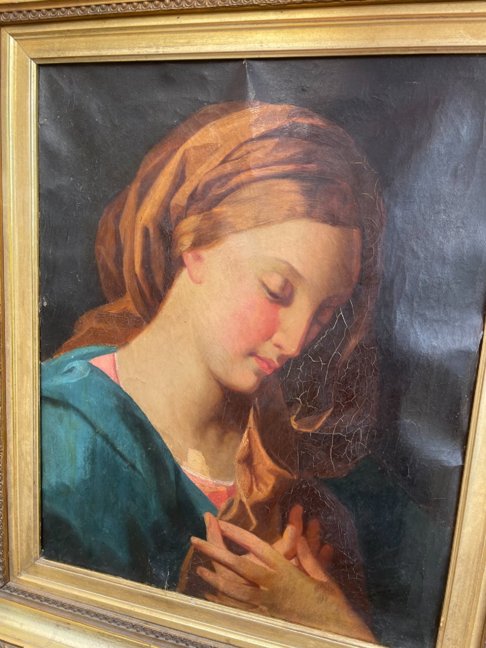 An 18th-century oil painting depicting the Virgin Mary with downcast eyes and folded hands, set within a moulded gilt wood frame. View VIII