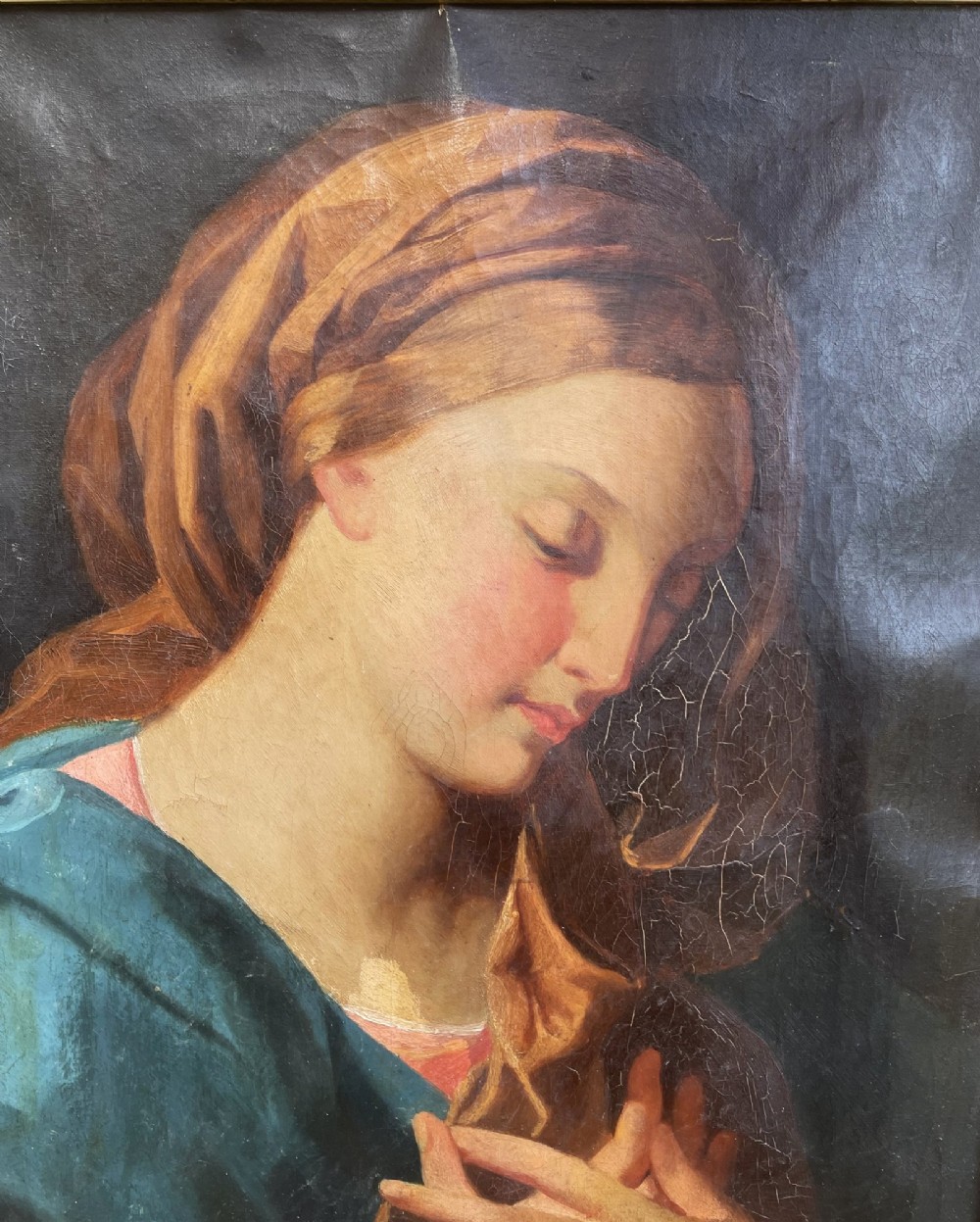 An 18th-century oil painting depicting the Virgin Mary with downcast eyes and folded hands, set within a moulded gilt wood frame. View IX