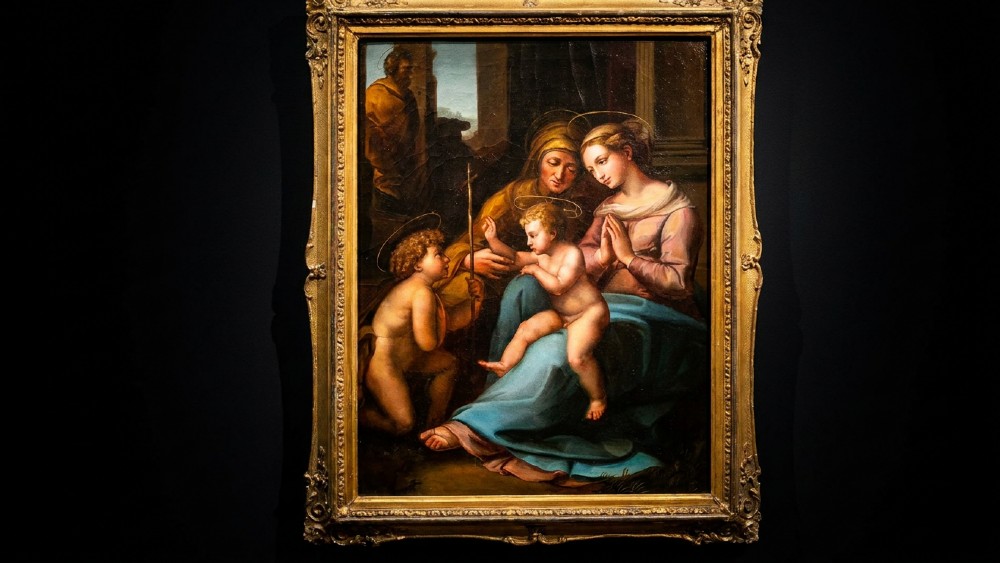 An oil painting on canvas depicting the Madonna and Child with Saint Elizabeth and John the Baptist set within a carved gold-gilded frame.