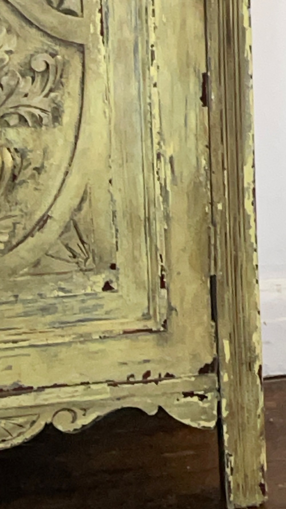 An antique French provincial sideboard featuring distressed yellow painted wood, two carved panel doors with urn motifs, two upper drawers, and a pink marble top surface. View XI