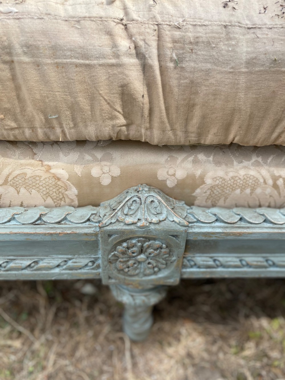 A French Louis XVI style daybed featuring a grey-painted curved timber frame with woven cane panels, fitted with a cream linen mattress cushion and two bolster pillows. View VI