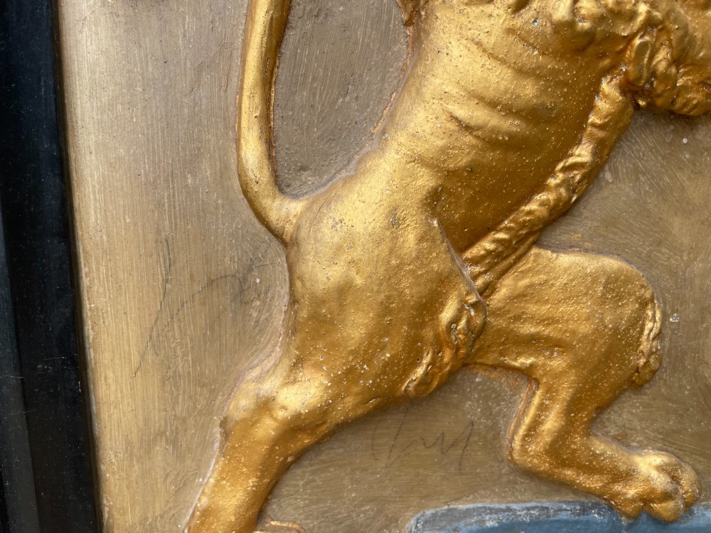 A framed 19th-century Dutch heraldic marriage plaque depicting two carved gilt lion supporters holding alliance coats of arms under a helmet crest and motto banner. View VIII