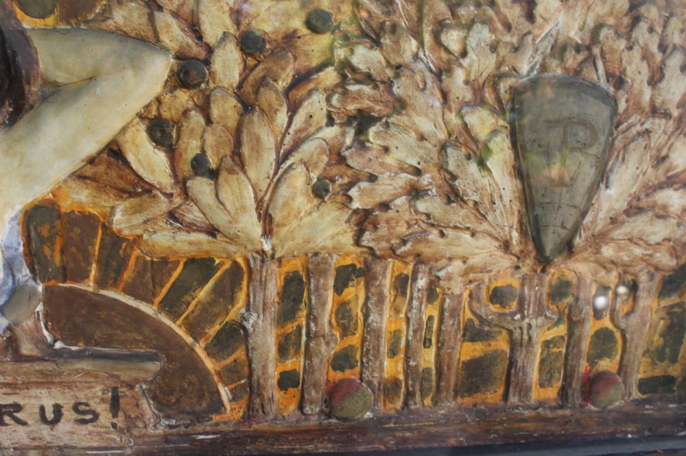 A rectangular Arts and Crafts polychrome plaster relief featuring a central classical figure framed by trees and inscribed Ave Epicurus within a gilt frame. View V