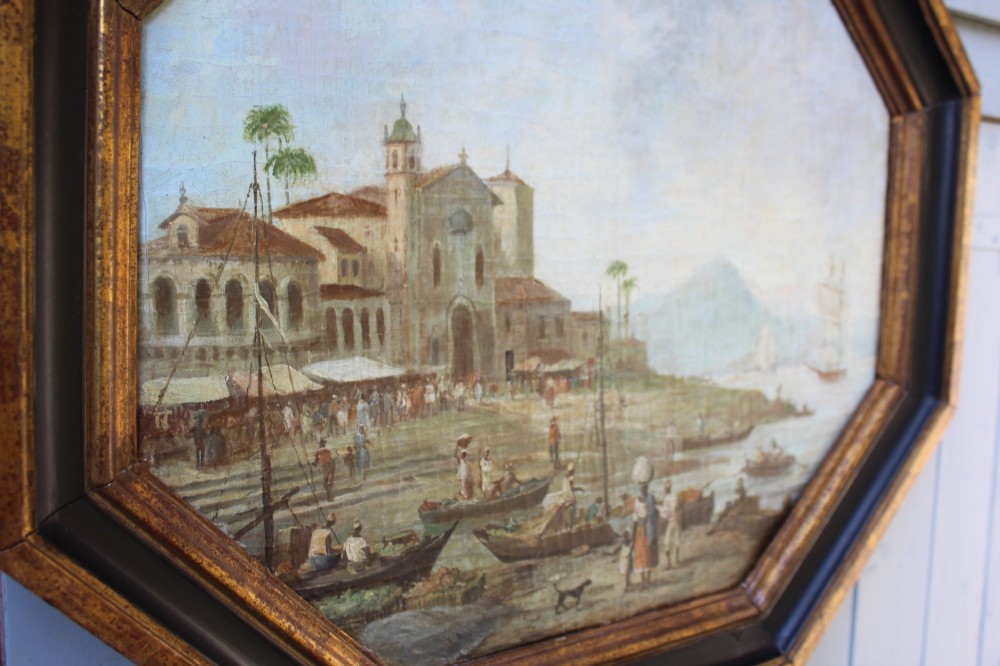An early nineteenth-century octagonal oil painting depicting a harbour scene in Rio de Janeiro, housed in a moulded gilt and ebonised wooden frame. View V