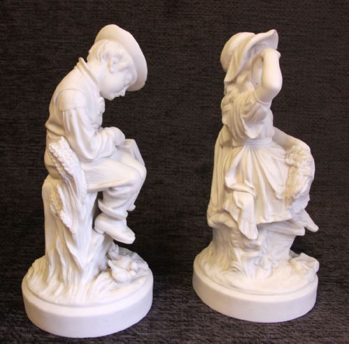 fig 1. A pair of white Victorian Parian bisque porcelain figurines depicting a sleeping boy and an awake girl on circular bases inscribed Fast Asleep and Wide Awake.