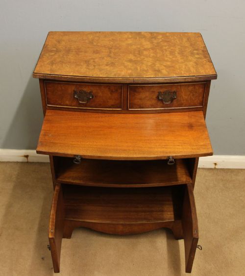 A pair of antique burr walnut bedside cabinets featuring top drawers, pull-out slides, open middle shelves, and double-door lower cupboards. View IX