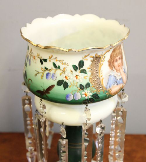 A Victorian opaque white and green glass mantle lustre featuring a hand-painted portrait vignette of a child, floral enamel accents, and suspended crystal prisms. View VII