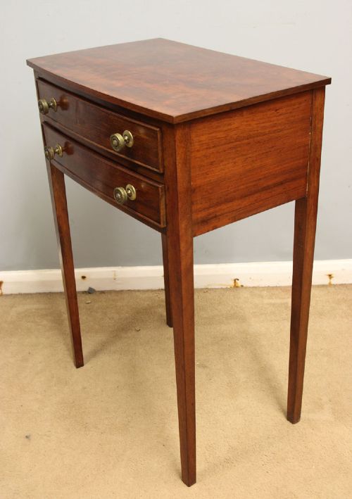 A pair of slim mahogany bedside tables, each featuring two drawers with brass knobs and tall square tapered legs. View V
