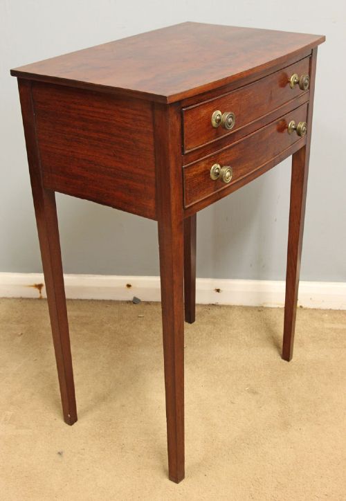 A pair of slim mahogany bedside tables, each featuring two drawers with brass knobs and tall square tapered legs. View VI