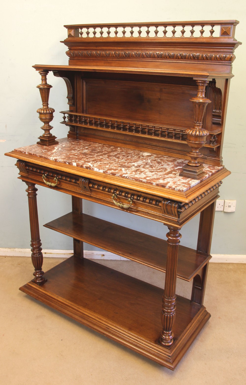 An antique French walnut buffet server featuring a marble top, spindle galleries, turned column supports, and open lower shelves. View XIII