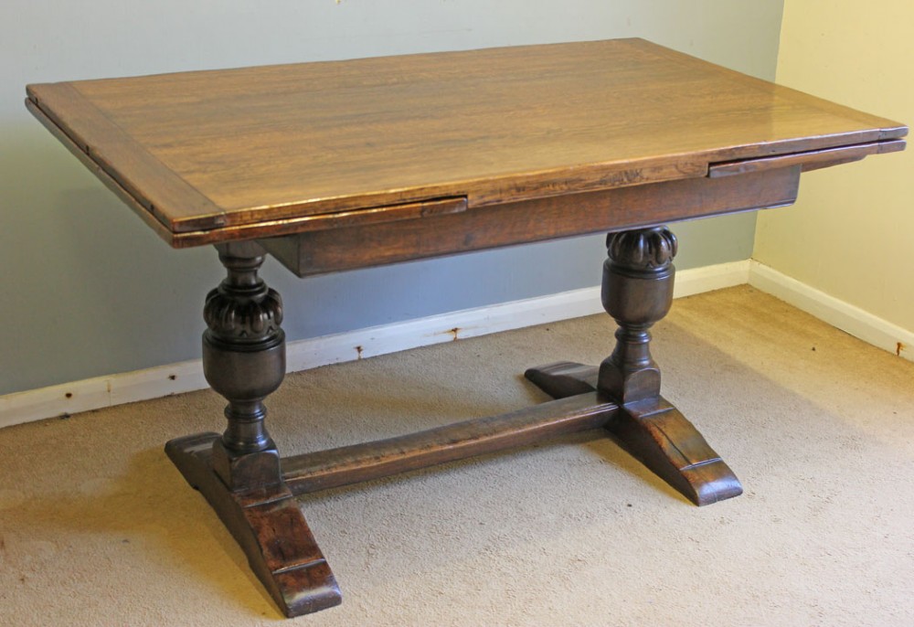 A solid oak extending refectory dining table featuring carved bulbous legs and an H-stretcher base. View II
