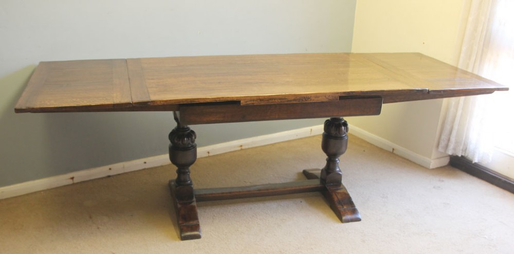 A solid oak extending refectory dining table featuring carved bulbous legs and an H-stretcher base. View III