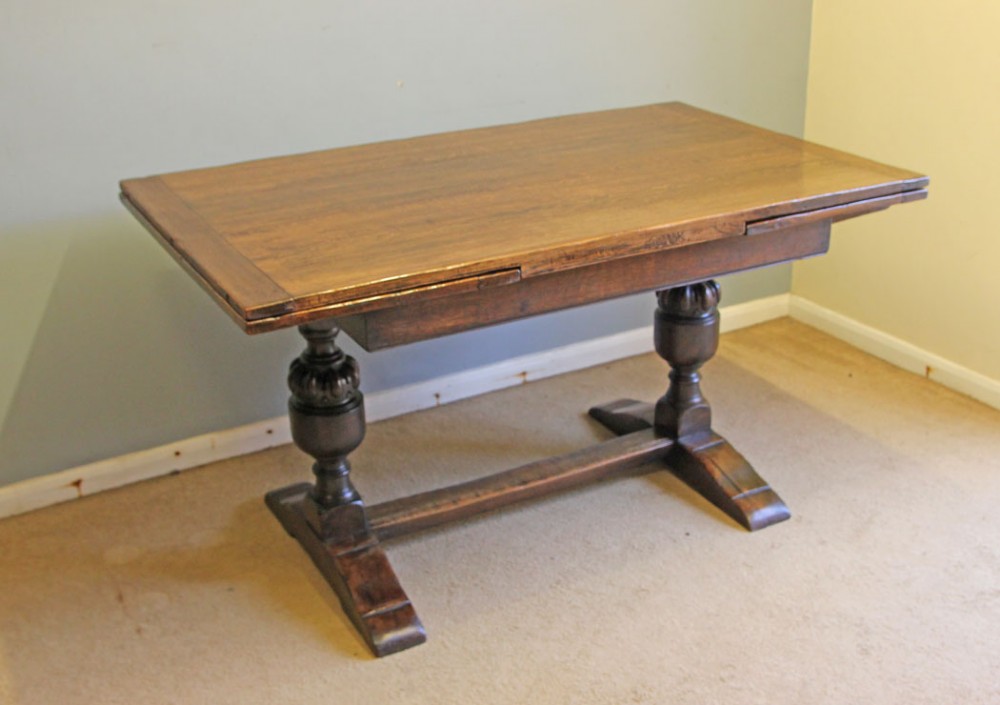 A solid oak extending refectory dining table featuring carved bulbous legs and an H-stretcher base. View V