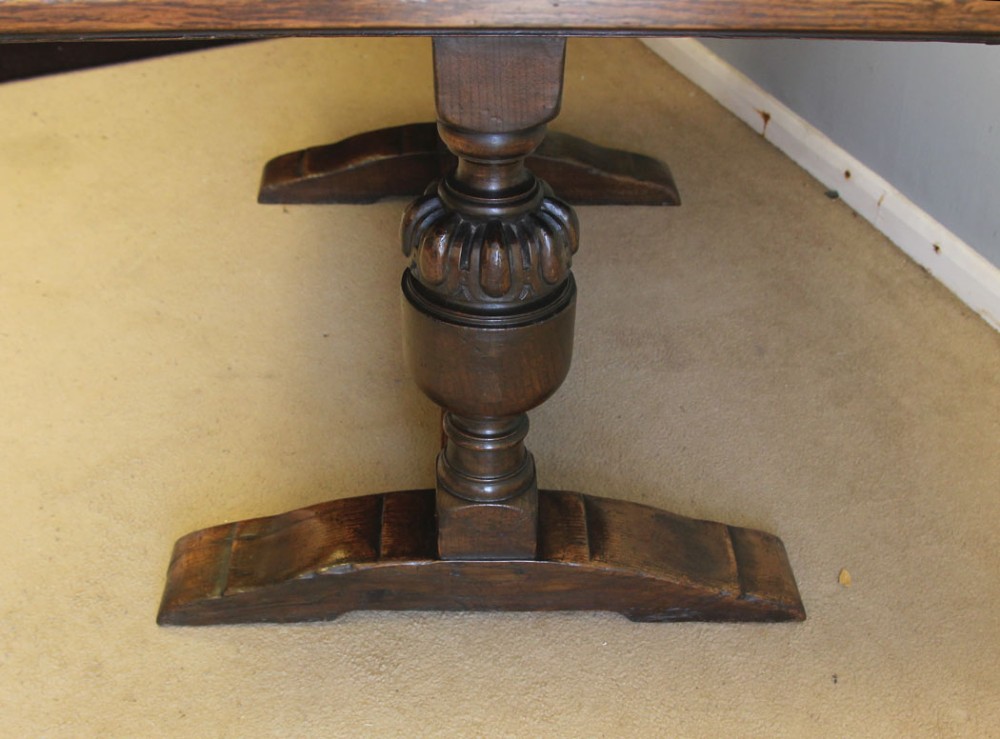 A solid oak extending refectory dining table featuring carved bulbous legs and an H-stretcher base. View VI