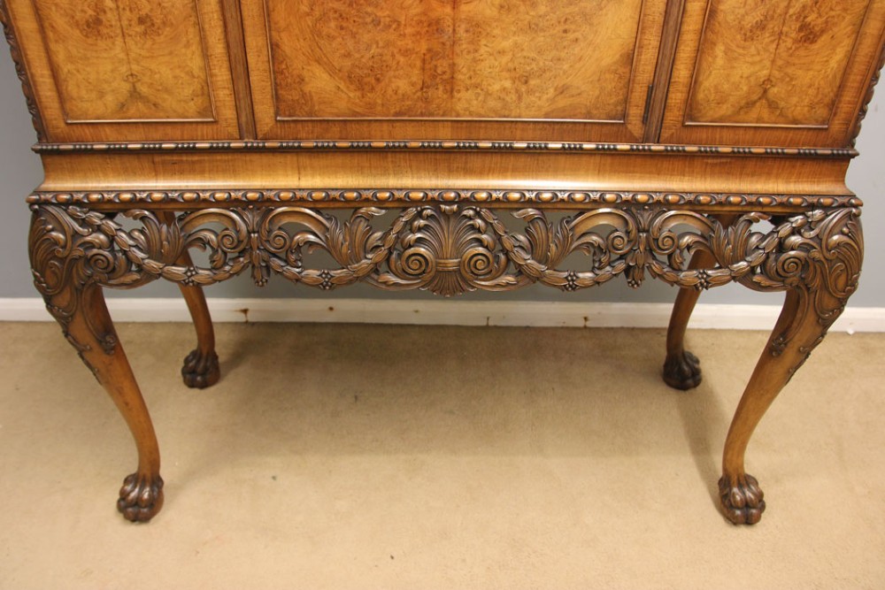 An antique burr walnut three-door side cabinet on an intricately carved stand with cabriole legs and claw and ball feet. View IX