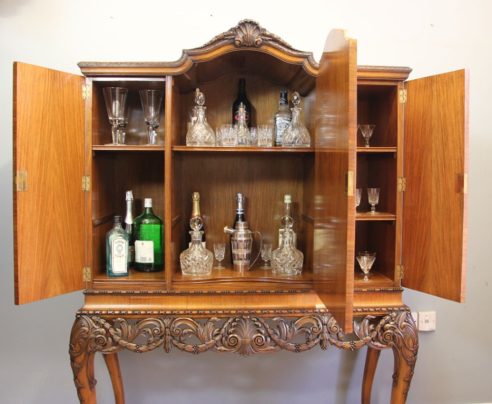 An antique burr walnut three-door side cabinet on an intricately carved stand with cabriole legs and claw and ball feet. View XV