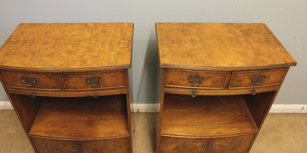 A pair of antique burr walnut bedside cabinets featuring top drawers, pull-out slides, open middle shelves, and double-door lower cupboards. View V