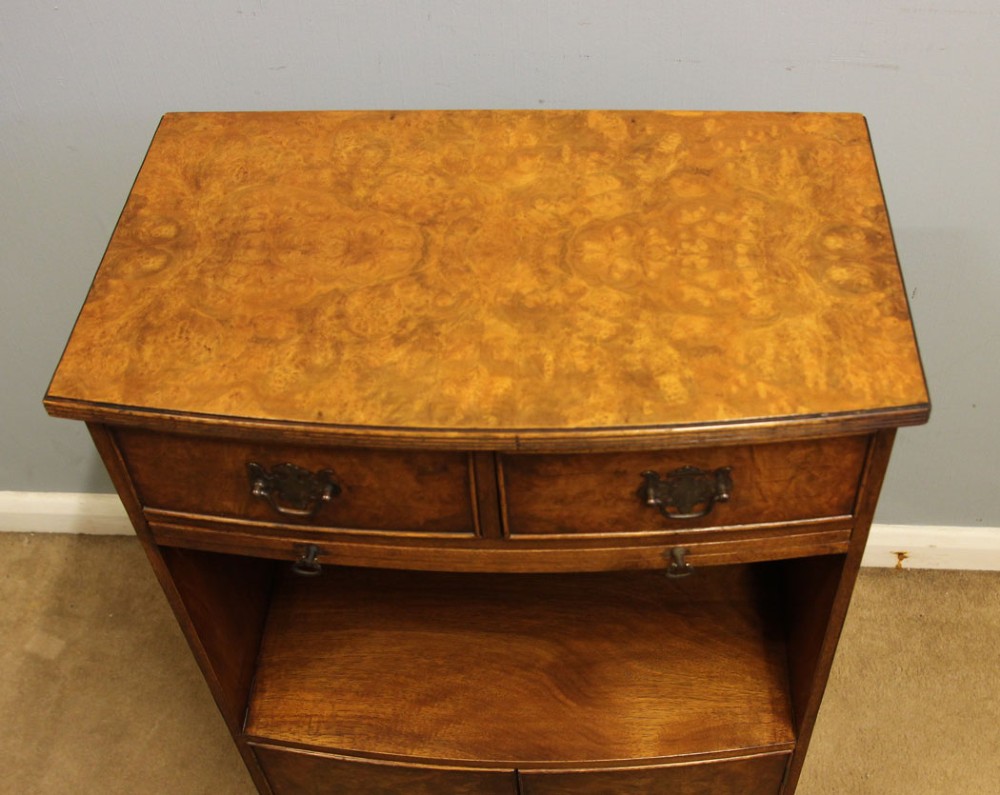 A pair of antique burr walnut bedside cabinets featuring top drawers, pull-out slides, open middle shelves, and double-door lower cupboards. View VI
