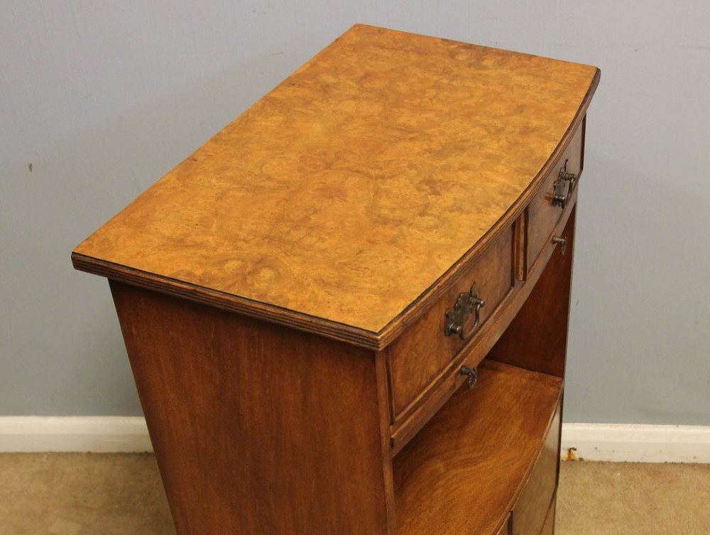 A pair of antique burr walnut bedside cabinets featuring top drawers, pull-out slides, open middle shelves, and double-door lower cupboards. View XI