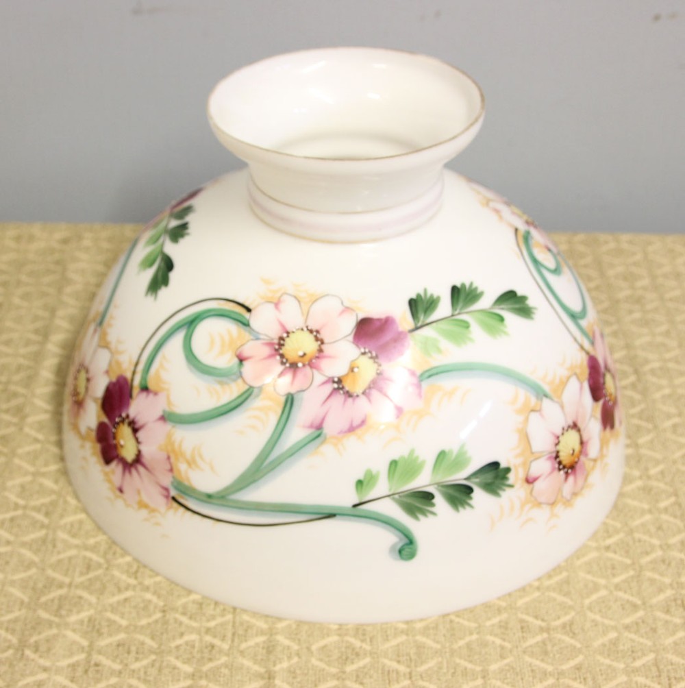 A domed white opaline glass oil lamp shade decorated with hand-painted pink floral motifs and green foliage. View VI